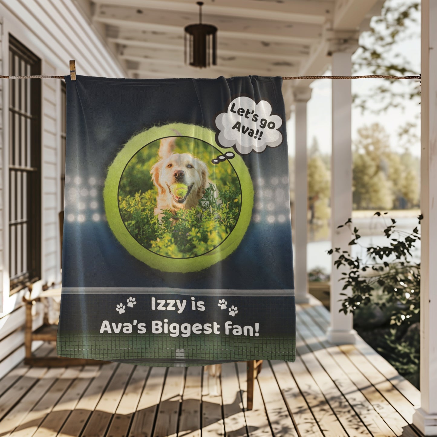 Personalized dog tennis fan blanket with photo and text hanging outdoors on a farmhouse porch clothesline, showing full design in natural light.
