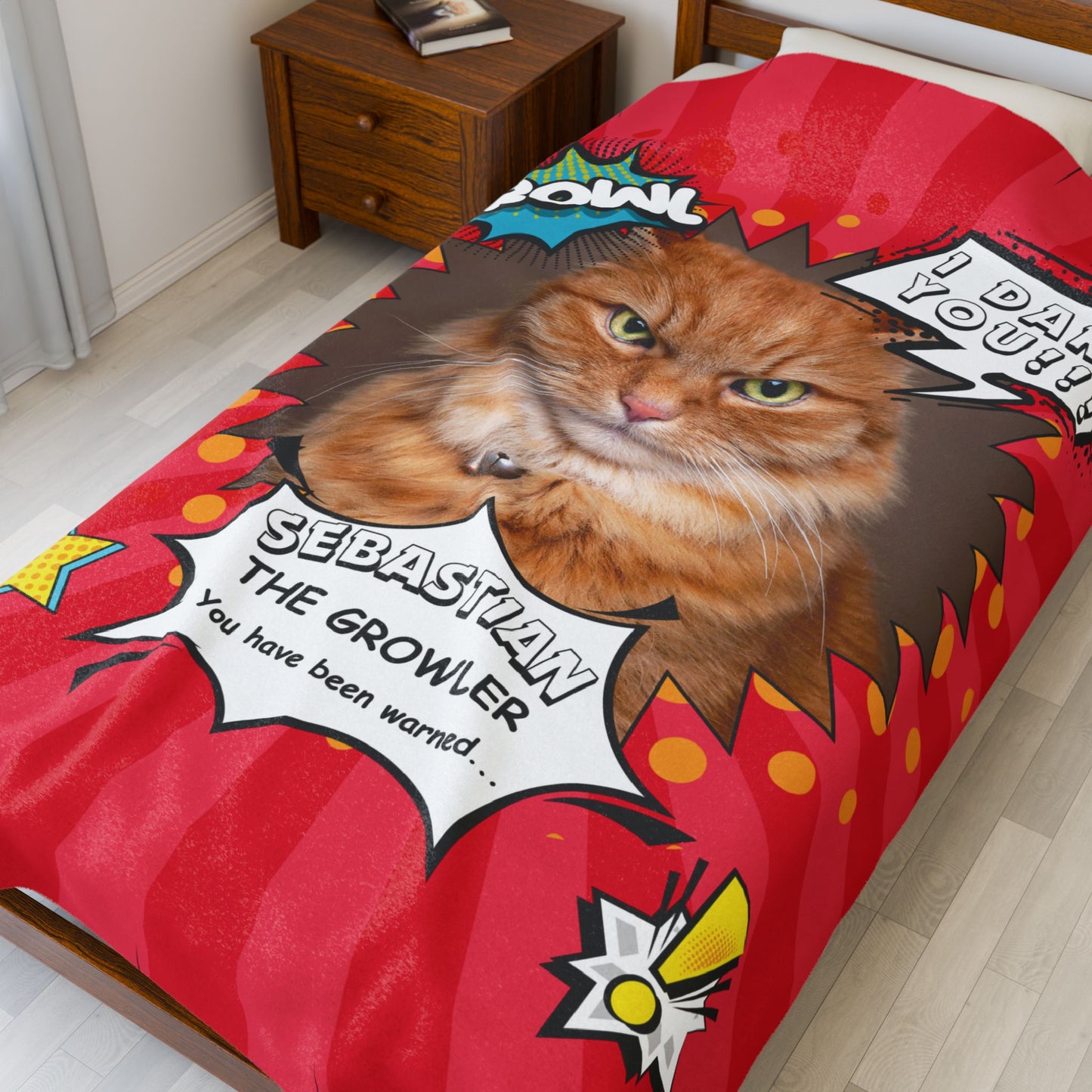 Personalized comic-style cat blanket featuring an orange tabby named Sebastian with bold text “The Growler” displayed on a bed in a cozy bedroom