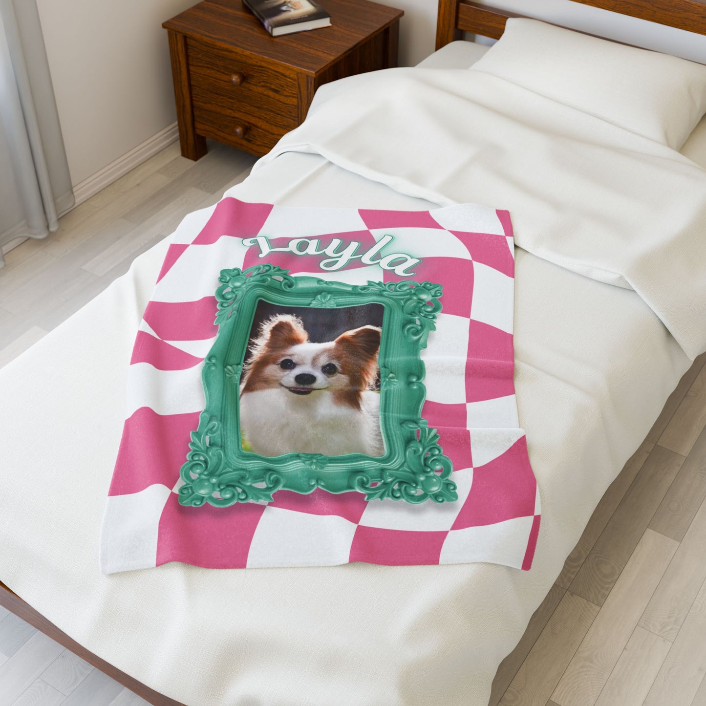 Custom pink checkered dog blanket with name Layla and photo in teal frame, displayed folded on bed