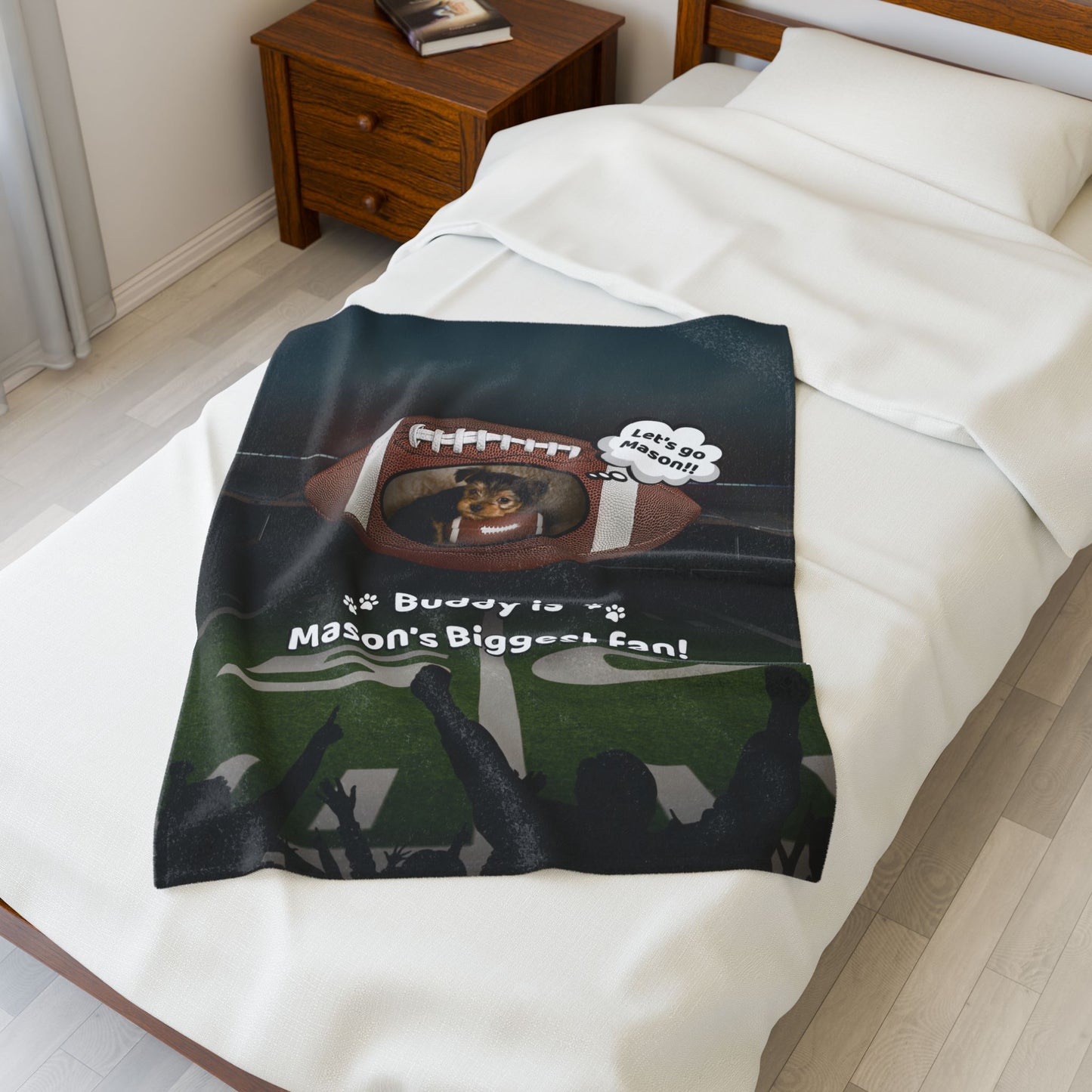 Small football-themed custom blanket on a twin bed, featuring a personalized photo of a dog holding a football with the text “Buddy is Mason’s Biggest Fan” — ideal as a baby or pet blanket
