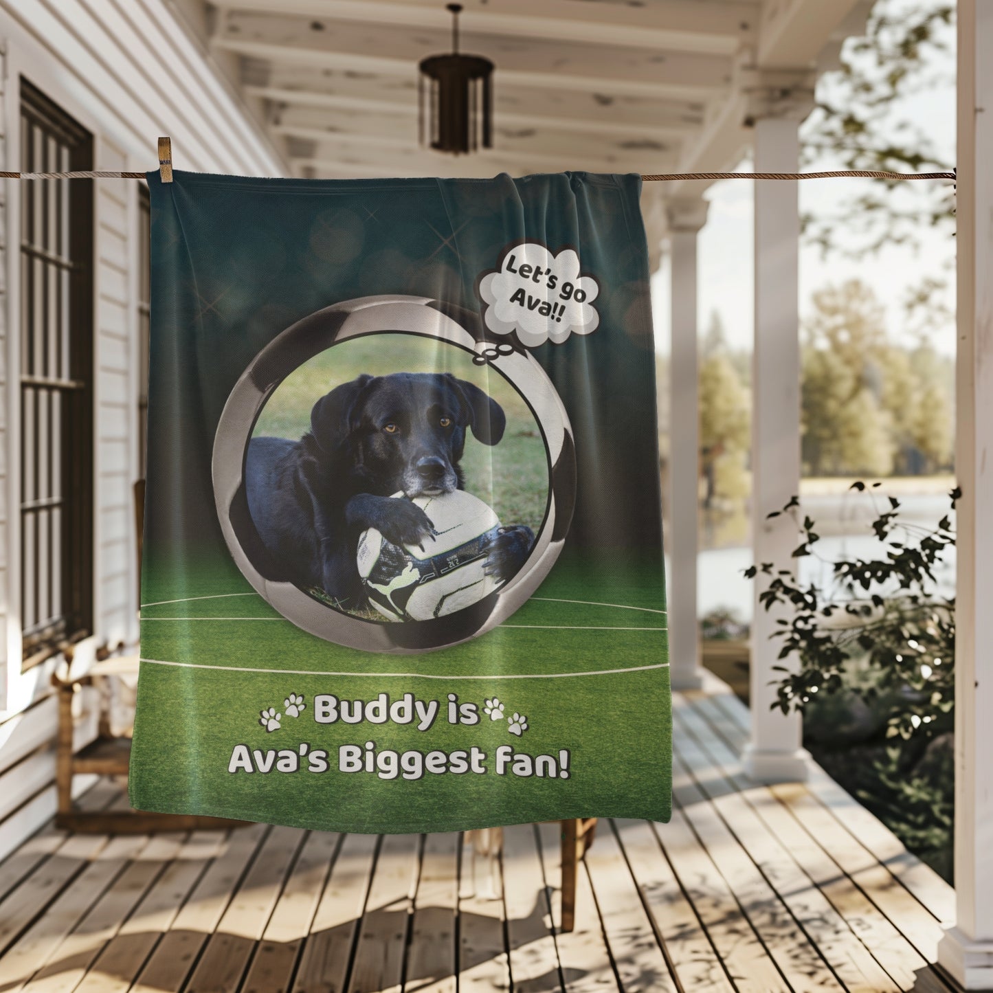 Soccer-themed personalized dog blanket with Buddy and “Ava’s Biggest Fan” text, hanging on a porch clothesline with a cozy outdoor background