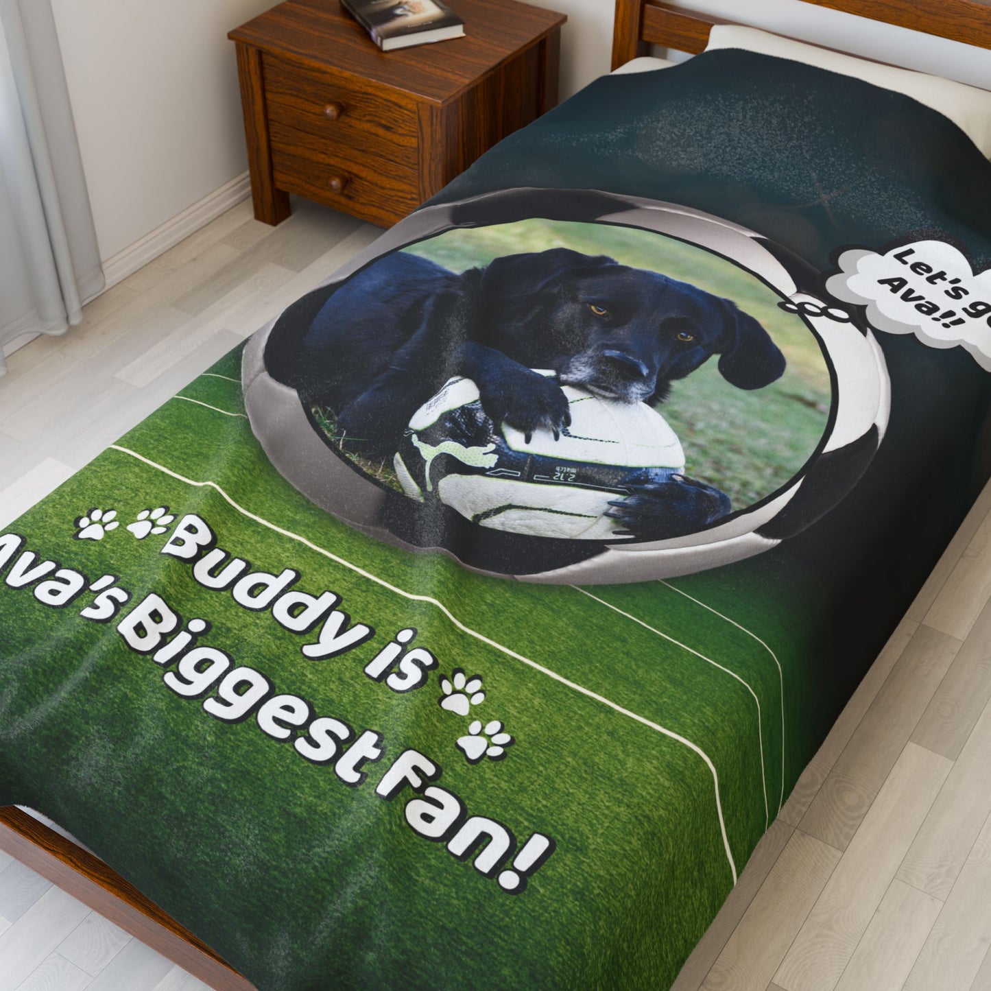 Oversized soccer dog blanket featuring Buddy with a soccer ball and “Ava’s Biggest Fan” message, displayed on a full bed for size and impact