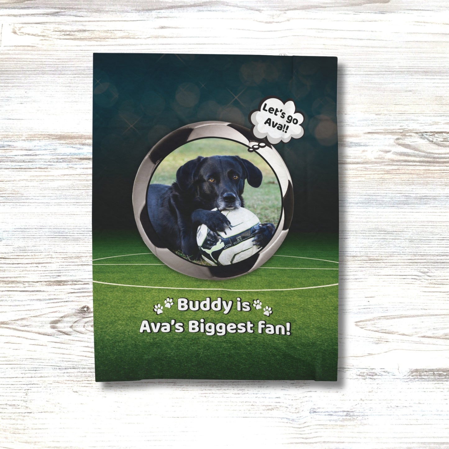 Custom soccer dog blanket with Buddy and the message “Buddy is Ava’s Biggest Fan,” displayed on a white wood floor for a clean, lifestyle look