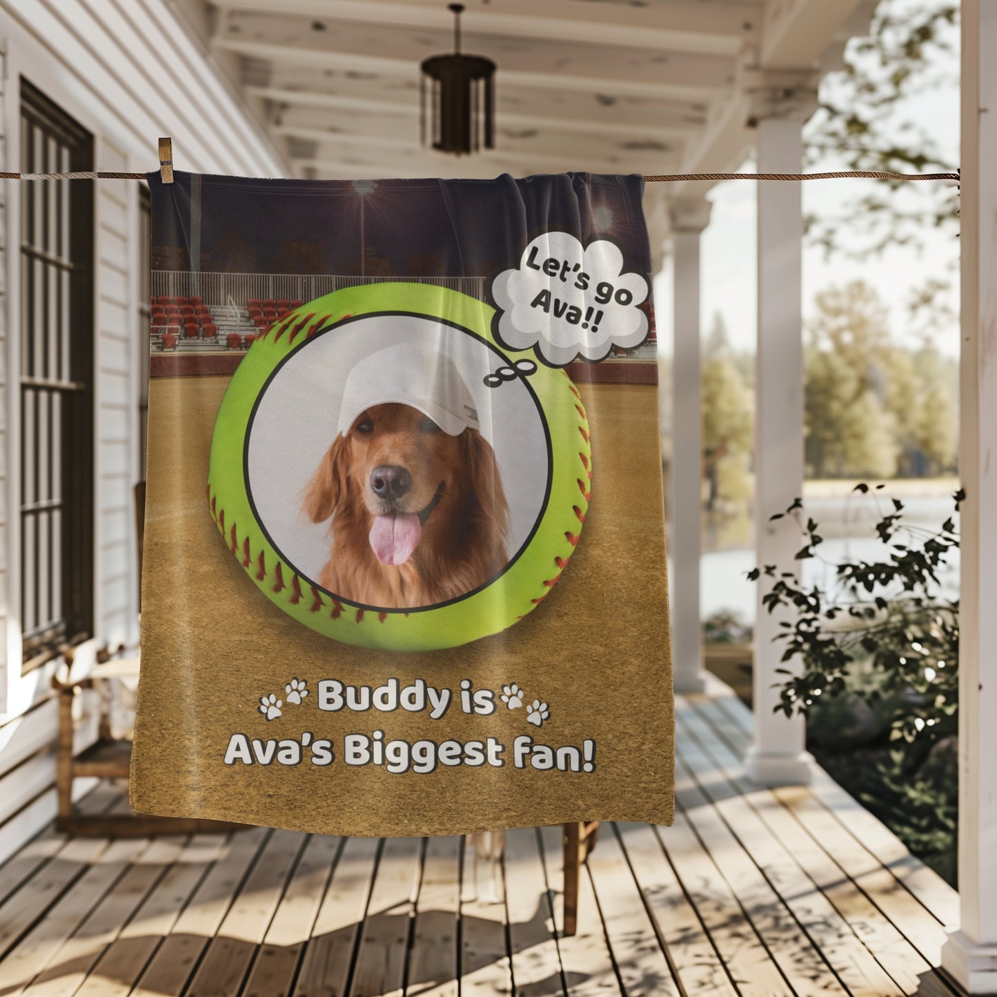 Personalized softball dog blanket featuring Buddy and the phrase “Buddy is Ava’s Biggest Fan,” shown hanging on a porch clothesline with scenic outdoor backdrop — perfect for game day coziness
