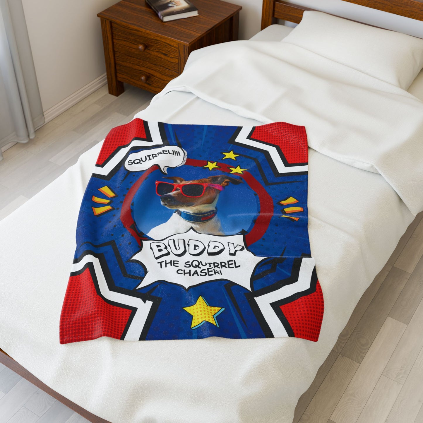 Personalized Squirrel Chaser dog blanket featuring Buddy, folded on top of a white bed, comic-style design with bold red, blue, and yellow colors
