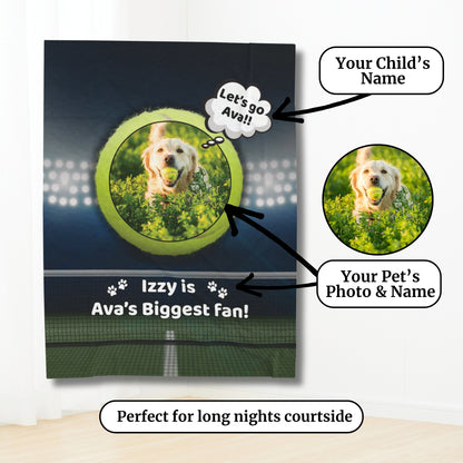 Personalized tennis-themed blanket hanging against a white wall, featuring a golden retriever with a tennis ball, labeled with “Izzy is Ava’s Biggest Fan!” and annotation bubbles showing custom options for child’s name and pet photo, with the phrase “Perfect for long nights courtside.”