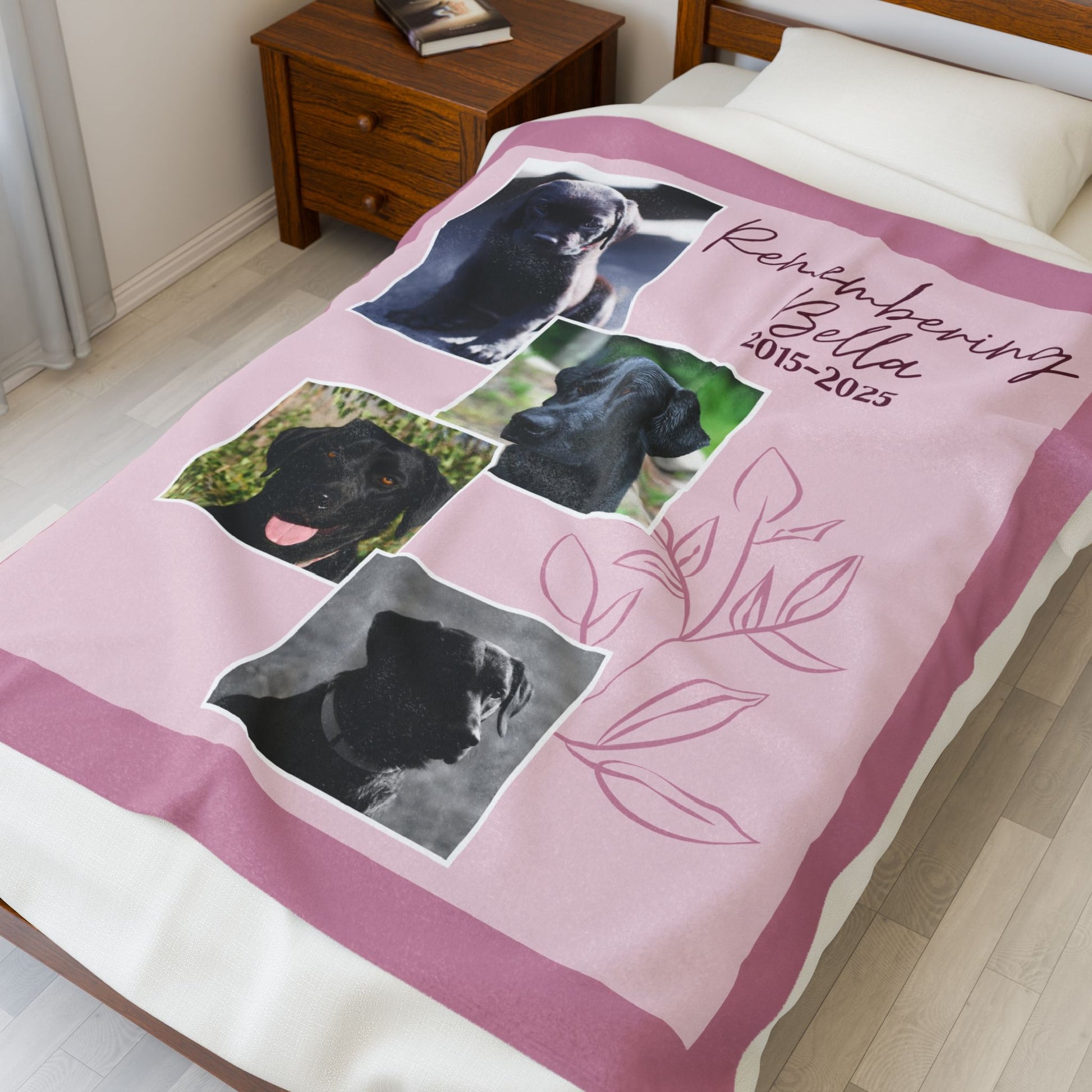 Personalized Dusty Rose pet memorial blanket on bed with four dog photos, remembrance dates, and soft pink floral line art