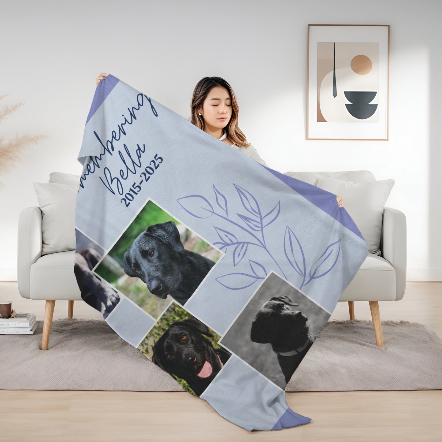 Woman holding Evening Lilac pet memorial blanket with four dog photos, remembrance dates, and a floral outline design