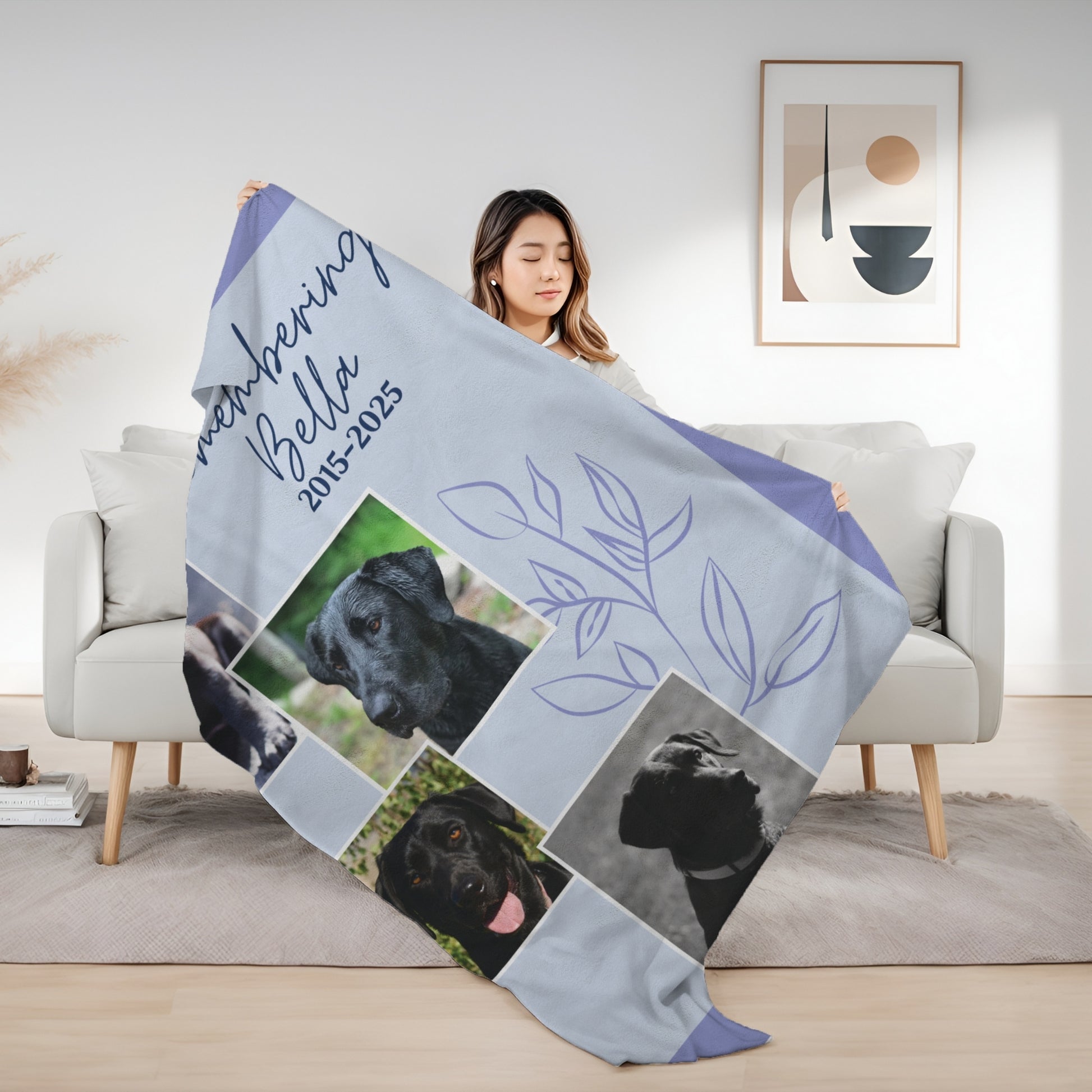 Woman holding Evening Lilac pet memorial blanket with four dog photos, remembrance dates, and a floral outline design