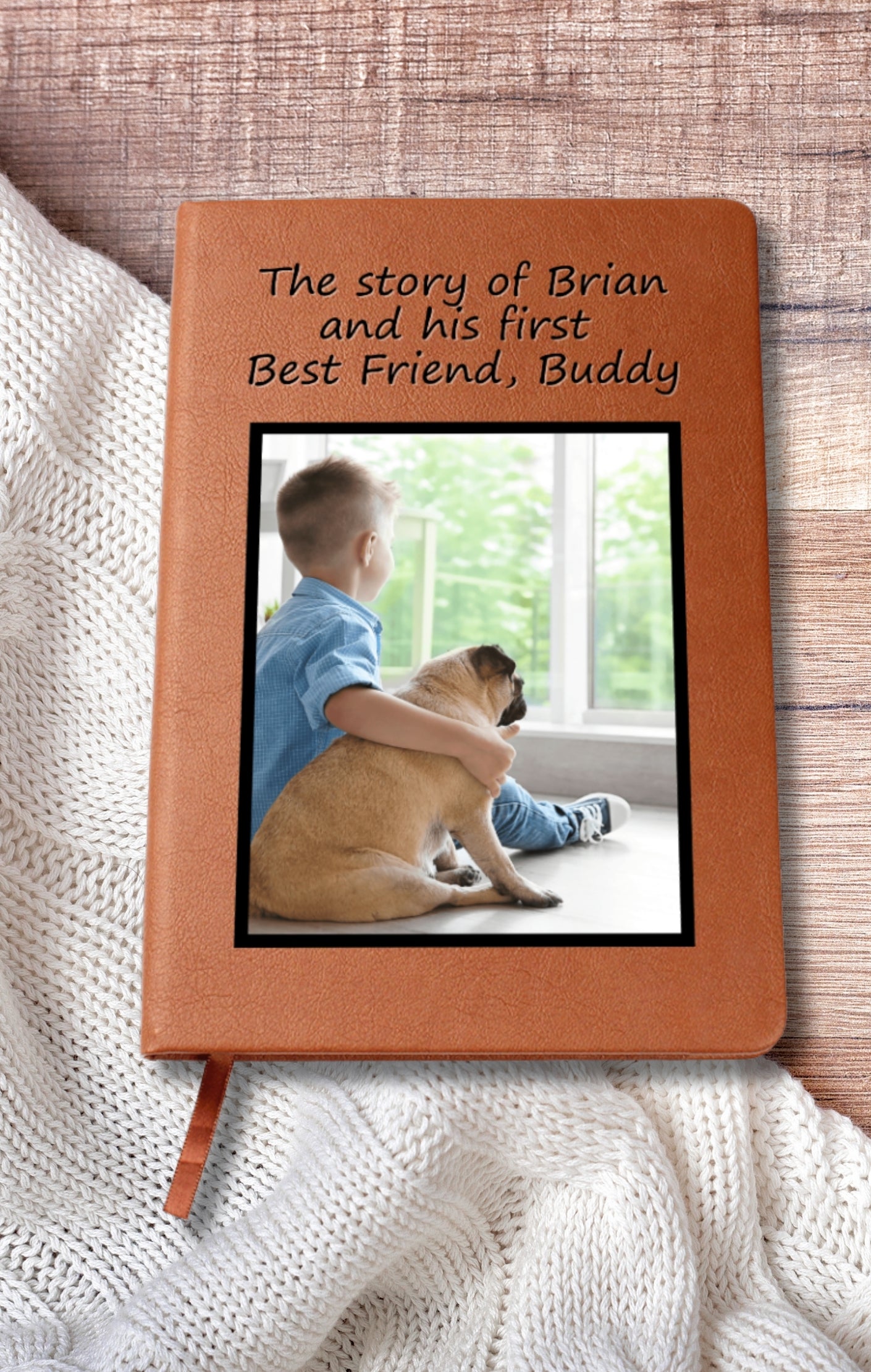 Pet and child memory journal on a table with a folded baby blanket, ideal for gifting"