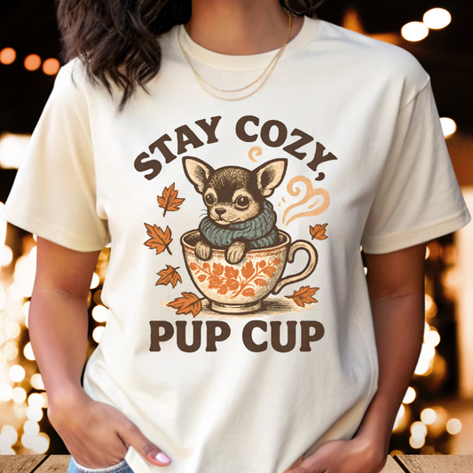 Woman wearing natural color t-shirt with “Stay Cozy Pup Cup” Chihuahua in teacup fall design