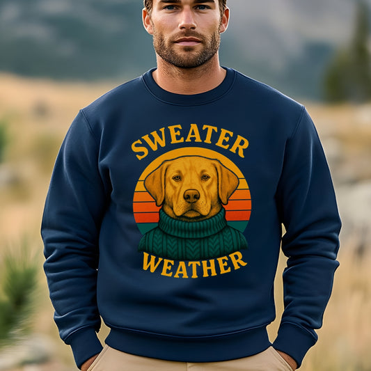 Man wearing navy “Sweater Weather” sweatshirt with yellow Labrador in green knit sweater and retro sunset design.