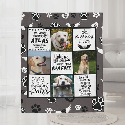 Personalized dog memorial blanket with photos and tribute quotes, displayed in a cozy gray living room with neutral decor and armchair. Fleece blanket features angel paw design and custom pet name.