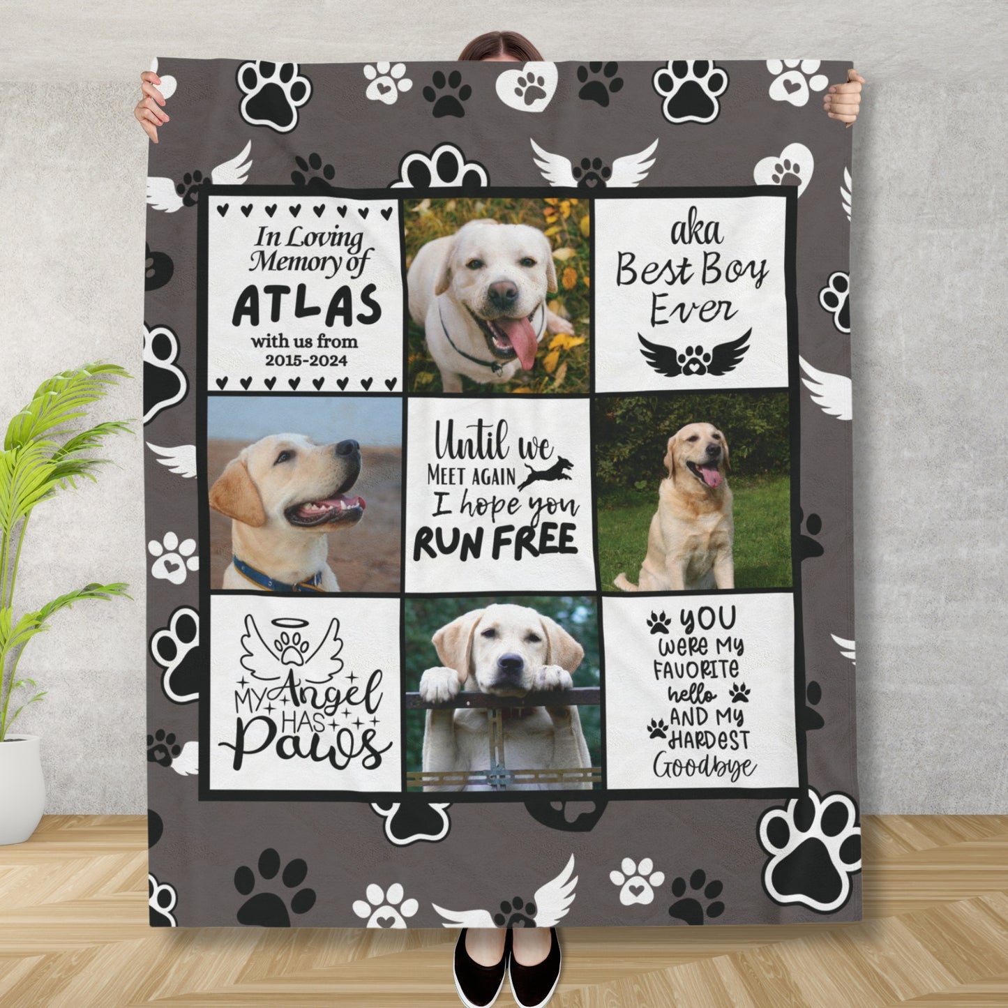Woman holding personalized dog memorial blanket with photo collage, tribute messages, and angel paw background. Charcoal fleece throw in remembrance of a beloved pet.