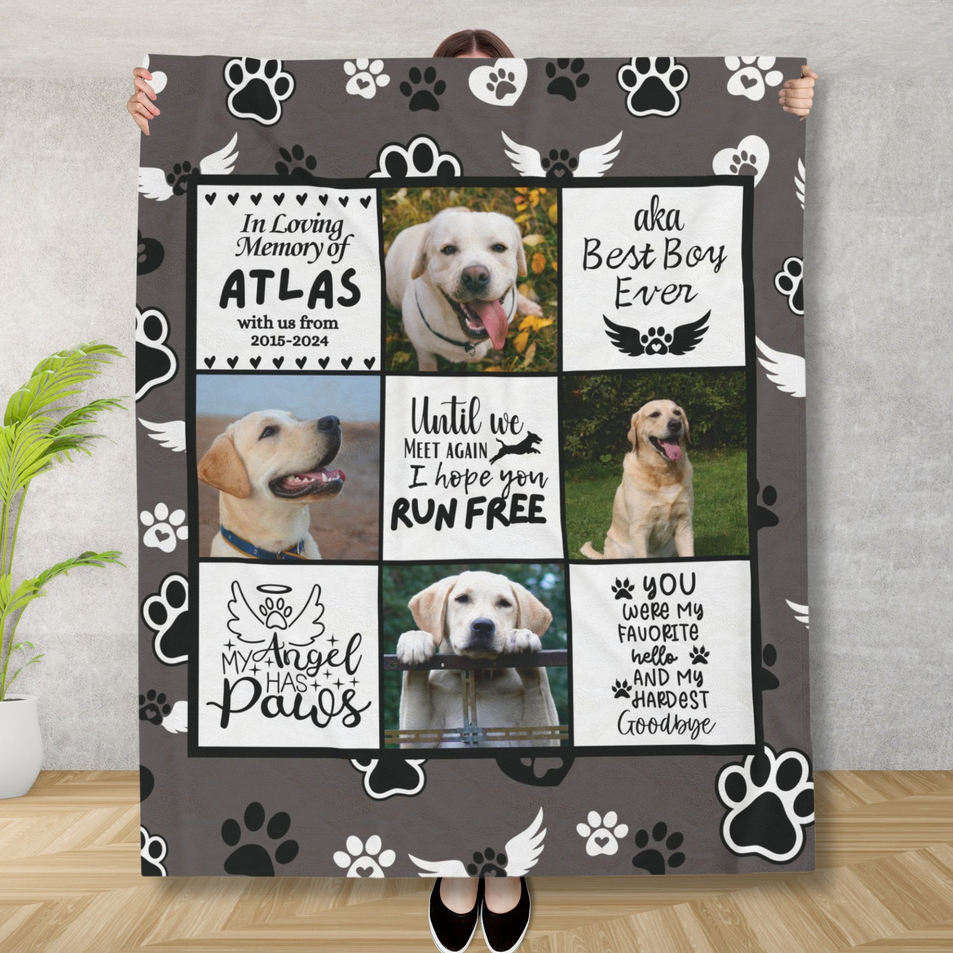 Woman holding personalized dog memorial blanket with photo collage, tribute messages, and angel paw background. Charcoal fleece throw in remembrance of a beloved pet.