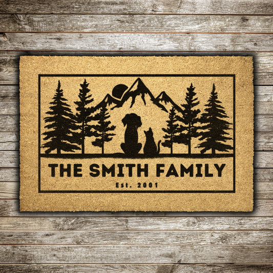 Dog and cat admire mountains customizable coir rug, personalized doormat with family name, durable and fade-resistant, ideal for pet-friendly entryways with a scenic mountain design.