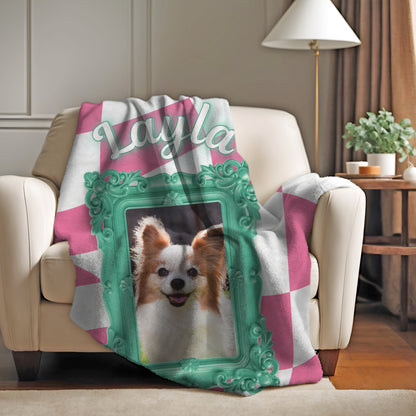 Custom dog photo blanket with pink and white checkered design, teal frame, and name Layla draped over armchair in cozy living room