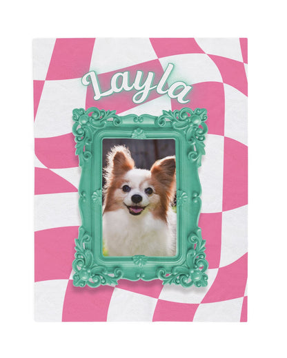 Full view of a personalized pet blanket with pink checkered background, the name Layla, and framed dog photo in teal green
