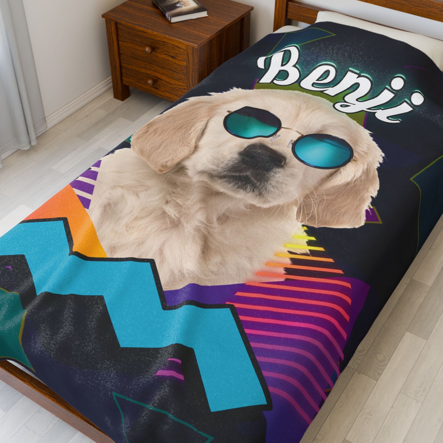Personalized dog blanket featuring Benji with sunglasses in retro neon design, laid out on a white bed with wood nightstand in background