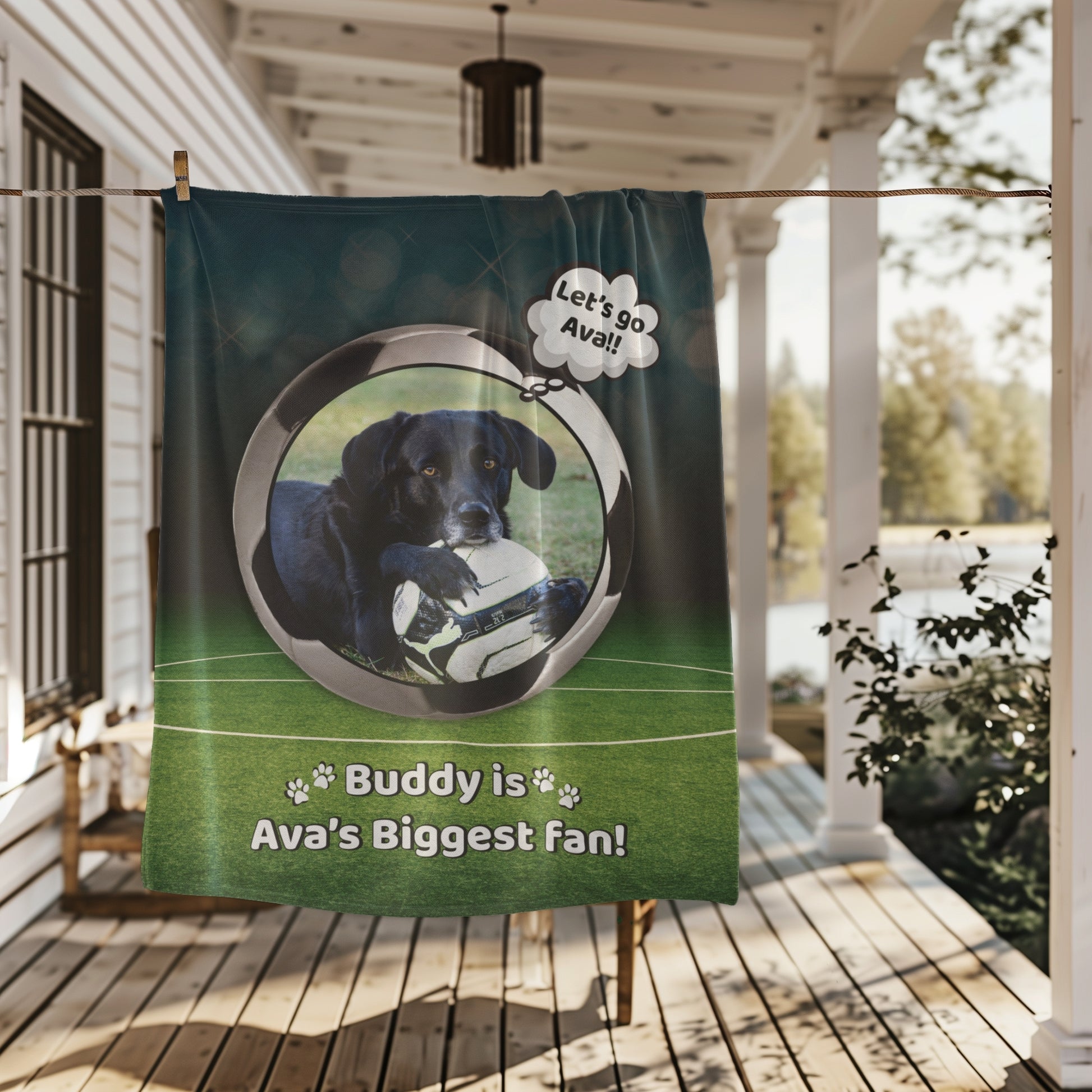 Soccer-themed personalized dog blanket with Buddy and “Ava’s Biggest Fan” text, hanging on a porch clothesline with a cozy outdoor background