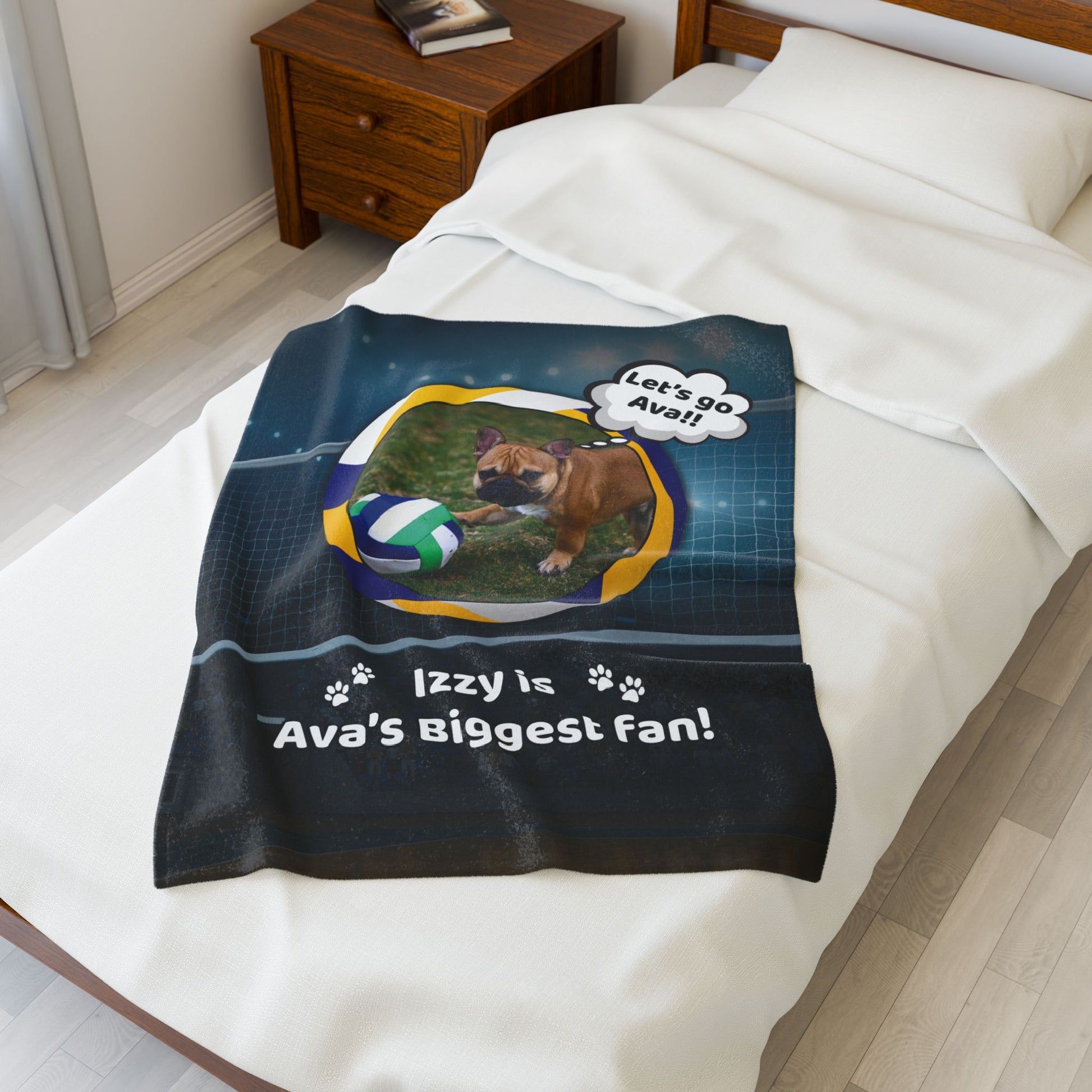 Small personalized volleyball blanket with Izzy the French Bulldog and custom name, displayed on a white twin bed.